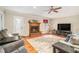 Cozy living room with a fireplace, hardwood floors, neutral paint colors, and comfortable seating at 469 Kimberly Ct, Mcdonough, GA 30252