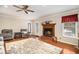 Cozy living room with a fireplace, hardwood floors, neutral paint colors, and comfortable seating at 469 Kimberly Ct, Mcdonough, GA 30252