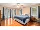 Comfortable main bedroom with hardwood floors, ceiling fan, and natural light from many windows at 469 Kimberly Ct, Mcdonough, GA 30252