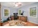 Home office space with wood desk, hardwood floors and natural light from multiple windows at 469 Kimberly Ct, Mcdonough, GA 30252
