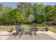Inviting backyard patio with rocking chairs, potted plants, and a serene view of the green lawn at 513 Huntgate Rd, Woodstock, GA 30189