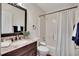 Clean bathroom with a shower, toilet, vanity, and sink with granite countertops at 513 Huntgate Rd, Woodstock, GA 30189