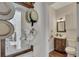 Stylish powder room with decorative accents, wood vanity, and modern fixtures; perfect for guests at 513 Huntgate Rd, Woodstock, GA 30189