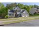 Traditional-style home with a manicured lawn, two-car garage, and mature trees at 513 Huntgate Rd, Woodstock, GA 30189