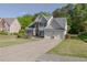 Inviting curb appeal with a well-maintained lawn, two-car garage and attractive exterior at 513 Huntgate Rd, Woodstock, GA 30189