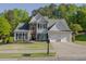 Beautifully landscaped front yard leads to this classic two-story home with attached two-car garage at 513 Huntgate Rd, Woodstock, GA 30189