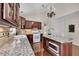 Bright kitchen features granite countertops, wood cabinets, stainless steel appliances and eat in space at 513 Huntgate Rd, Woodstock, GA 30189