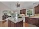 Charming kitchen featuring granite countertops, wood cabinets, hardwood floors and views into the adjacent living room at 513 Huntgate Rd, Woodstock, GA 30189