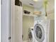 Bright laundry room featuring a washer, dryer, shelving, and storage at 513 Huntgate Rd, Woodstock, GA 30189