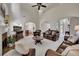 Bright and open living room with fireplace, large windows, and view into the kitchen at 513 Huntgate Rd, Woodstock, GA 30189