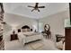A spacious bedroom with a tray ceiling, ceiling fan, and carpet floors at 513 Huntgate Rd, Woodstock, GA 30189