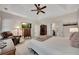 A spacious bedroom with a tray ceiling, ceiling fan, carpet floors, and a TV at 513 Huntgate Rd, Woodstock, GA 30189