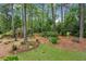 Enjoy a private backyard with mature trees, lush landscaping, and a bench for relaxation at 640 Sibley Se Frst, Marietta, GA 30067