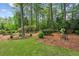 Private backyard featuring mature trees, lush landscaping, and a cozy bench for relaxation at 640 Sibley Se Frst, Marietta, GA 30067