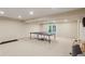 Spacious basement featuring neutral carpet, ping pong table, and access to the backyard at 640 Sibley Se Frst, Marietta, GA 30067