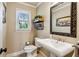 Powder room featuring a pedestal sink, decorative mirror, and stylish wall accents at 640 Sibley Se Frst, Marietta, GA 30067