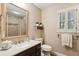 Bright bathroom with a white vanity, speckled quartz countertop, modern fixtures, and a shower-tub combination at 640 Sibley Se Frst, Marietta, GA 30067
