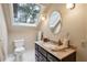 Bathroom featuring granite countertops, a vessel sink, a large window, and neutral colors, offering a serene and bright space at 640 Sibley Se Frst, Marietta, GA 30067