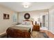 Cozy bedroom features a wooden bed frame, unique decor, and an ensuite bathroom, with hardwood floors and neutral walls at 640 Sibley Se Frst, Marietta, GA 30067