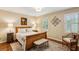 Bedroom with hardwood floors, a cozy armchair, and lots of natural light at 640 Sibley Se Frst, Marietta, GA 30067