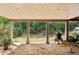 Enjoy outdoor living with this covered patio, featuring a stone floor and views of the lush backyard at 640 Sibley Se Frst, Marietta, GA 30067