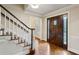 Inviting foyer with hardwood floors, stairs, and a beautifully crafted wooden front door with sidelights at 640 Sibley Se Frst, Marietta, GA 30067