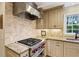 Gourmet kitchen with professional-grade appliances, custom backsplash, and ample counter space at 640 Sibley Se Frst, Marietta, GA 30067
