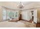 Spacious main bedroom with shuttered windows, hardwood floors, a decorative rug, and an elegant chair at 640 Sibley Se Frst, Marietta, GA 30067