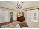 Bright main bedroom with large windows, hardwood floors, plenty of closet space, and ensuite bath at 640 Sibley Se Frst, Marietta, GA 30067