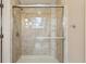 Tiled walk-in shower with a glass door features a built-in shelves and shower head, offering a modern and clean aesthetic at 640 Sibley Se Frst, Marietta, GA 30067