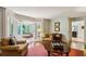 This bright sunroom offers access to the kitchen and an outside view with a pair of comfortable armchairs at 640 Sibley Se Frst, Marietta, GA 30067