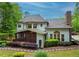 Inviting home back exterior with screened porch, patio, and a well-maintained yard with mature trees at 104 Fairway Overlook, Woodstock, GA 30188