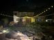 Inviting backyard with a string-lit patio, garden area and mature landscaping at 104 Fairway Overlook, Woodstock, GA 30188
