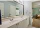 Bathroom features double sinks with vanity and mirror, with an open view to the bedroom at 104 Fairway Overlook, Woodstock, GA 30188