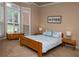 Serene bedroom with natural light, wood furniture, and a calming color scheme at 104 Fairway Overlook, Woodstock, GA 30188