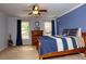 The bedroom showcases a ceiling fan, hardwood floors, and natural light from a window at 104 Fairway Overlook, Woodstock, GA 30188
