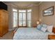 Comfortable bedroom featuring a patterned duvet, shuttered windows, and a cozy, welcoming ambiance at 104 Fairway Overlook, Woodstock, GA 30188