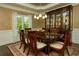 Formal dining room showcases elegant furniture, a china cabinet, and stylish decor at 104 Fairway Overlook, Woodstock, GA 30188