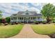 Charming home with a large front porch and meticulously maintained landscaping at 104 Fairway Overlook, Woodstock, GA 30188