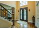 Grand foyer with detailed iron door, hardwood floors, and soaring ceilings offer a stylish welcome at 104 Fairway Overlook, Woodstock, GA 30188