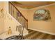 Hallway with staircase, mosaic tiled table, and decorative wall art with wine theme at 104 Fairway Overlook, Woodstock, GA 30188