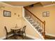 Hallway features a decorated staircase with a wrought iron banister and decorative wall art at 104 Fairway Overlook, Woodstock, GA 30188
