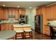 Spacious kitchen featuring modern appliances, an island with seating, and an open layout at 104 Fairway Overlook, Woodstock, GA 30188
