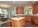 Inviting kitchen with stainless appliances, a center island, and an adjacent dining space at 104 Fairway Overlook, Woodstock, GA 30188