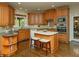 Bright kitchen featuring hardwood floors, stainless steel appliances, and a convenient center island at 104 Fairway Overlook, Woodstock, GA 30188