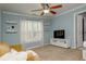 Cozy living room features built in shelves, window with blinds, and light blue walls at 104 Fairway Overlook, Woodstock, GA 30188