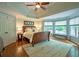 Main bedroom suite features tray ceilings, a bay window, and hardwood flooring at 104 Fairway Overlook, Woodstock, GA 30188