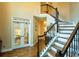 Elegant staircase with wood treads and iron spindles leads to the upper level at 104 Fairway Overlook, Woodstock, GA 30188
