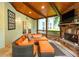 Relaxing sunroom features a stone fireplace, cozy seating, and natural light at 104 Fairway Overlook, Woodstock, GA 30188