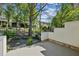Scenic backyard with trees, stone pavers and privacy wall with brick accents at 1294 Fernwood Ne Cir, Brookhaven, GA 30319